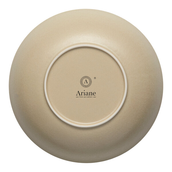 A white porcelain plate with a sand dollar design on the rim.