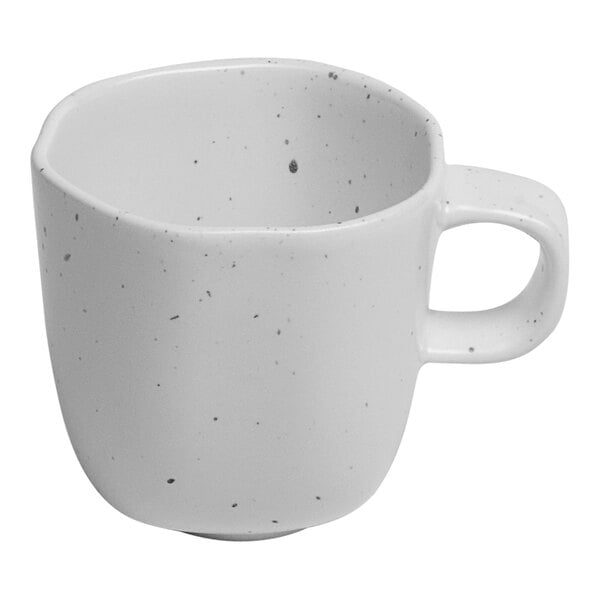 An Ariane white porcelain espresso cup with speckled dots.