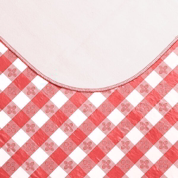 A red and white gingham vinyl table cover with a flannel back.