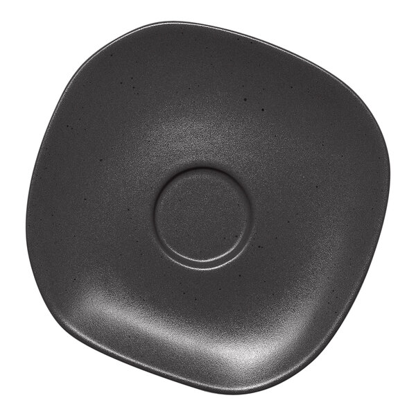 A charcoal grey Ariane porcelain saucer with dots in the center.