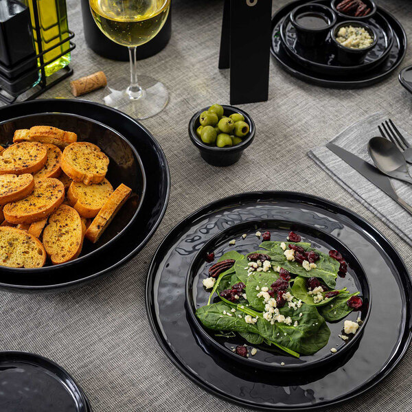 A black round melamine plate from the Tablecraft Ridge Collection, measuring 6 inches in diameter.