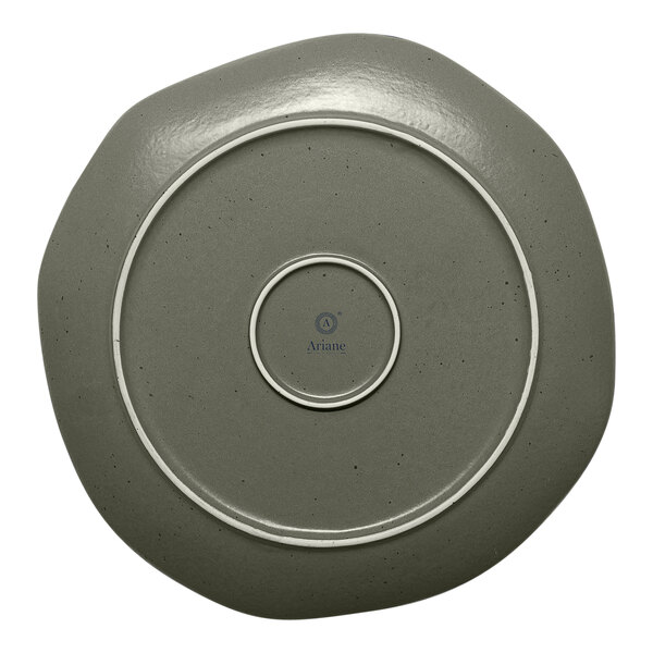 An Ariane Earth mist green porcelain plate with grey dots and a white border.