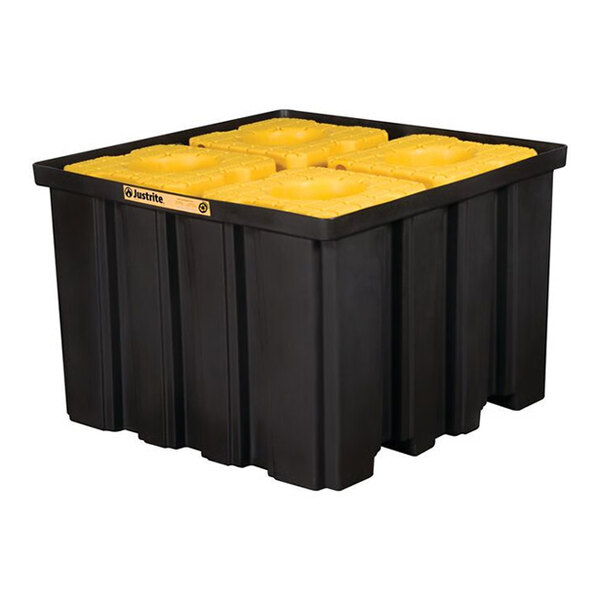A large black indoor pallet with yellow grates designed for holding IBC containers, featuring forklift pockets.