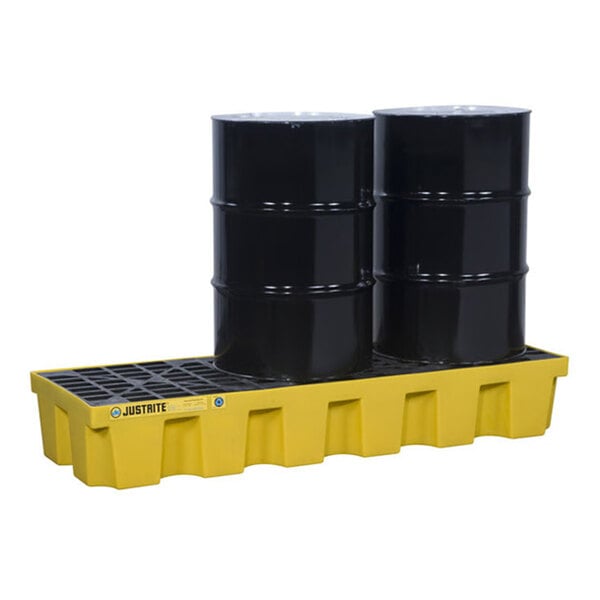 A yellow plastic in-line pallet with a drain, holding two black industrial drums.