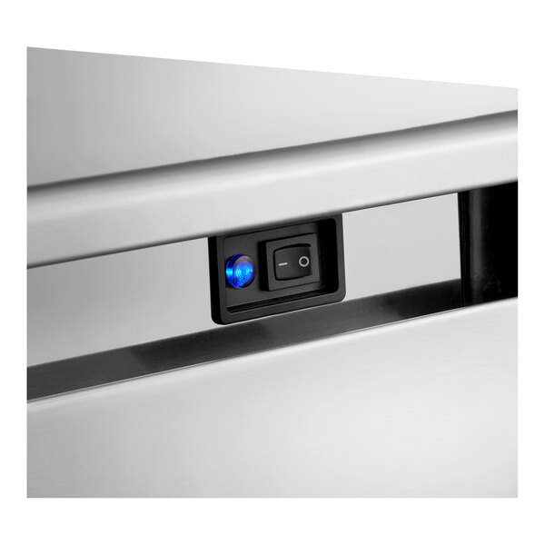 An air-cooled undercounter full cube ice machine with a control switch and indicator light on a stainless steel exterior.