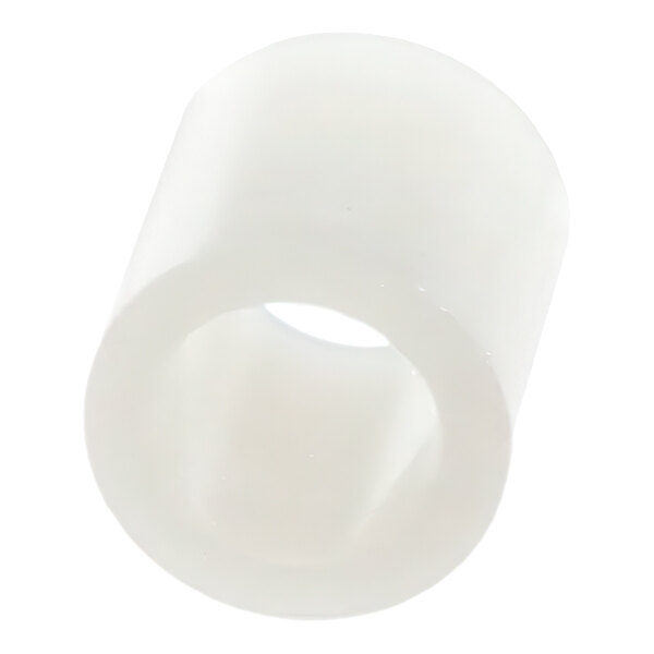 A close up of a white plastic spacer with a hole in it.