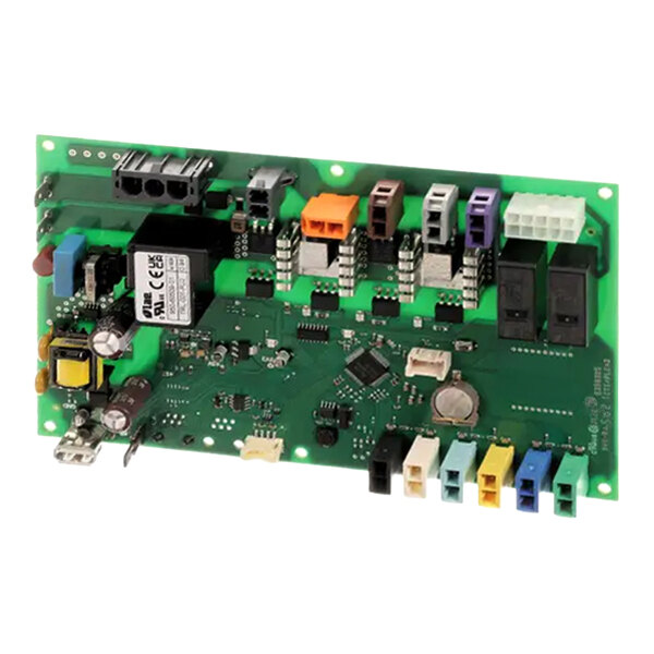 A green electronic circuit board with various colored connectors, relays, capacitors, and other electronic components mounted on it.