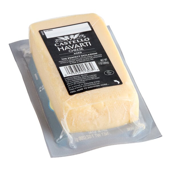 A 7-ounce block of Castello Aged Havarti cheese in vacuum-sealed packaging.