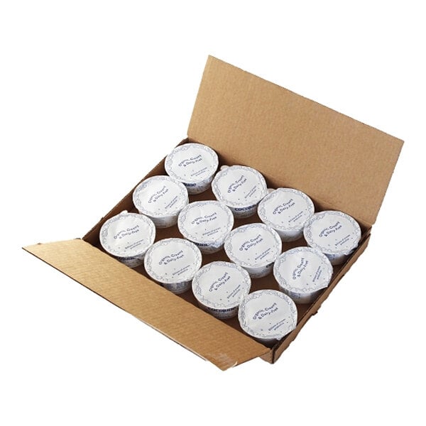 A white box of Cocojune Dairy-Free Unsweetened Pure Coconut Yogurt containers with blue writing.