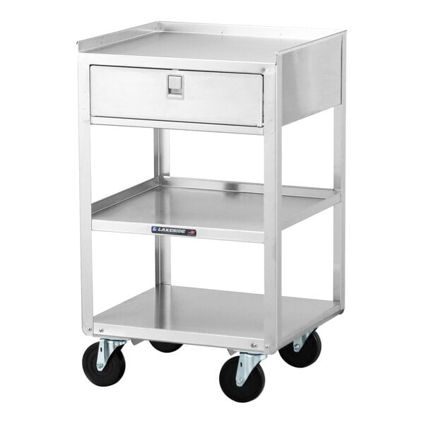 A stainless steel equipment stand with three shelves, a drawer, and casters.
