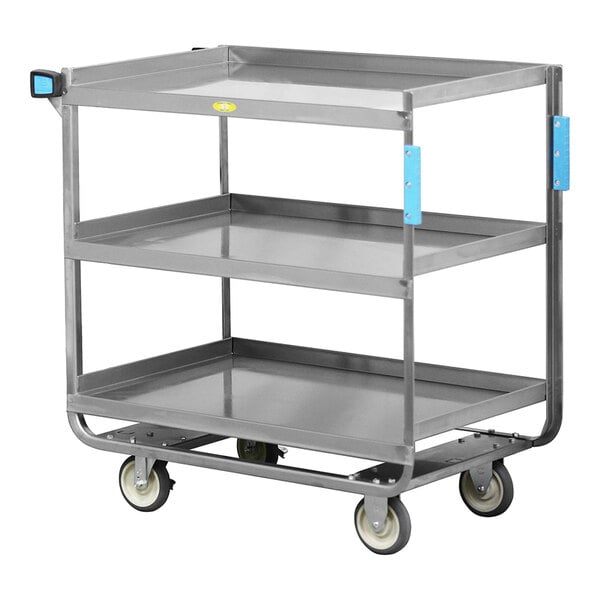 A heavy-duty three-shelf utility cart with a fixed push handle, bumpers, and caster wheels.