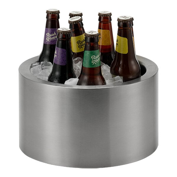 A brushed stainless steel party tub filled with ice and assorted bottled beverages.