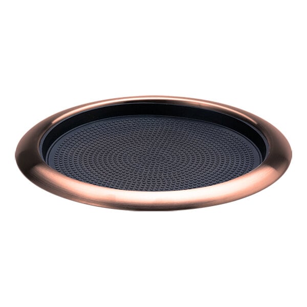 A round rose gold serving tray with a removable non-slip black insert.