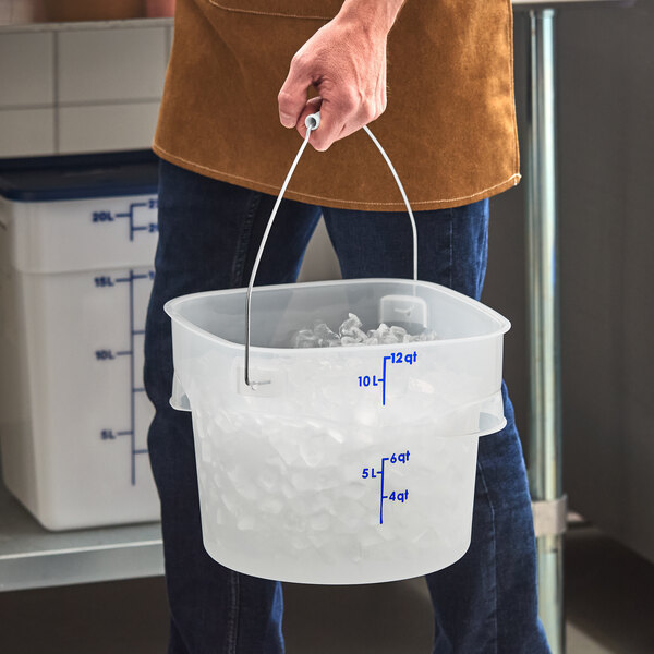 A translucent 12-quart round food storage pail with blue measurement markings and a metal bail handle, partially filled with ice.