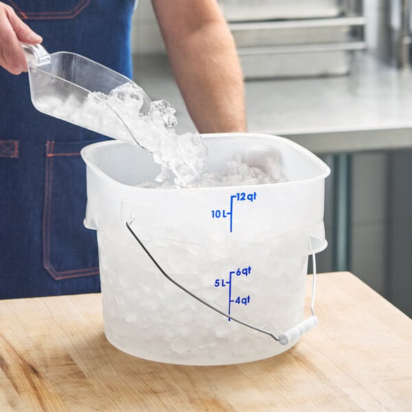 A translucent 12-quart round food storage pail with blue measurement markings and a metal bail handle, partially filled with ice.
