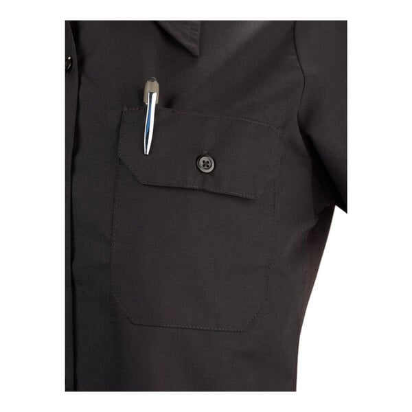A black short sleeve work shirt with a buttoned chest pocket containing a pen.