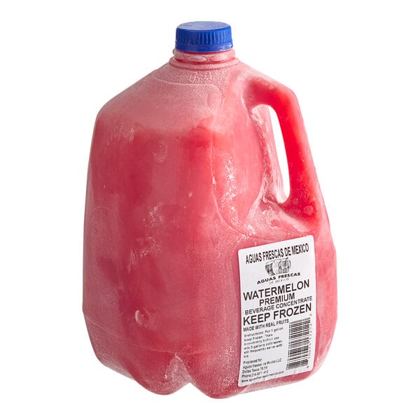 A gallon jug of frozen watermelon agua fresca concentrate with a blue cap and labeled for keeping frozen.