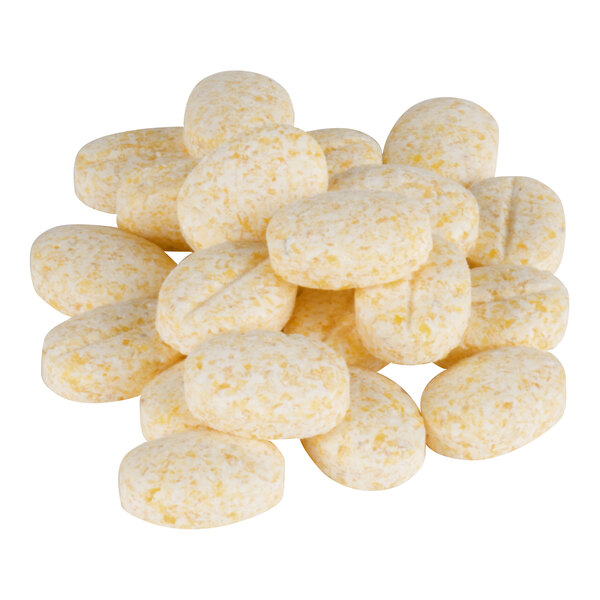 A pile of yellowish, oval-shaped coffee and espresso grinder cleaner granules.