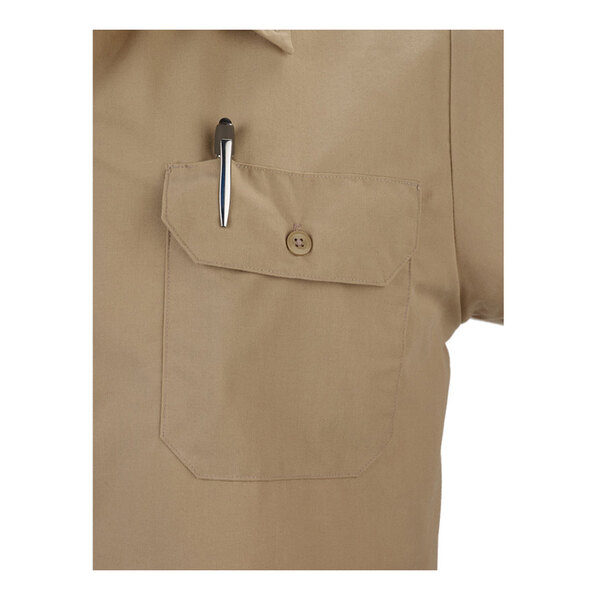 A khaki short sleeve work shirt with a buttoned chest pocket and a pen clipped to the pocket.