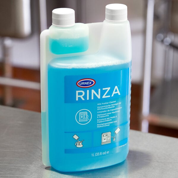 A 1-liter bottle of Urnex Rinza milk frother cleaner with a blue liquid inside.