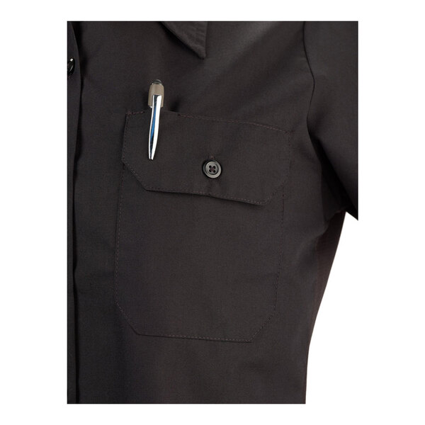 A black short sleeve women's work shirt in size 2XL with a buttoned chest pocket holding a pen.