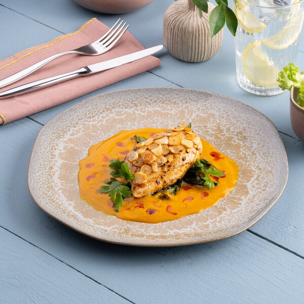 A gold and brown irregular round porcelain flat plate with a textured finish.