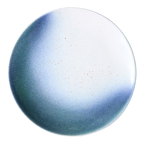 A round porcelain plate with a blue and white ombre design and a flat coupe shape.