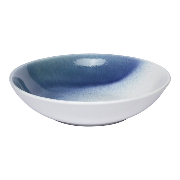 A round porcelain deep coupe plate with a blue and white ombre design.