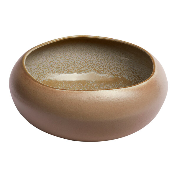 A large, round, gold and brown porcelain bowl with an organic shape and speckled interior.