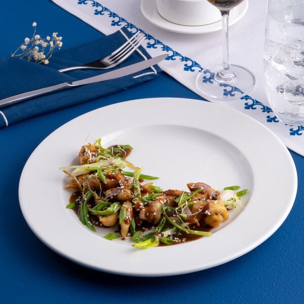A white round porcelain plate with an embossed wide rim, displayed with a food serving.