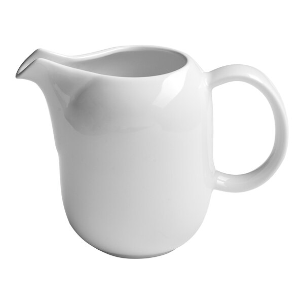 A small white porcelain creamer with a handle and spout.