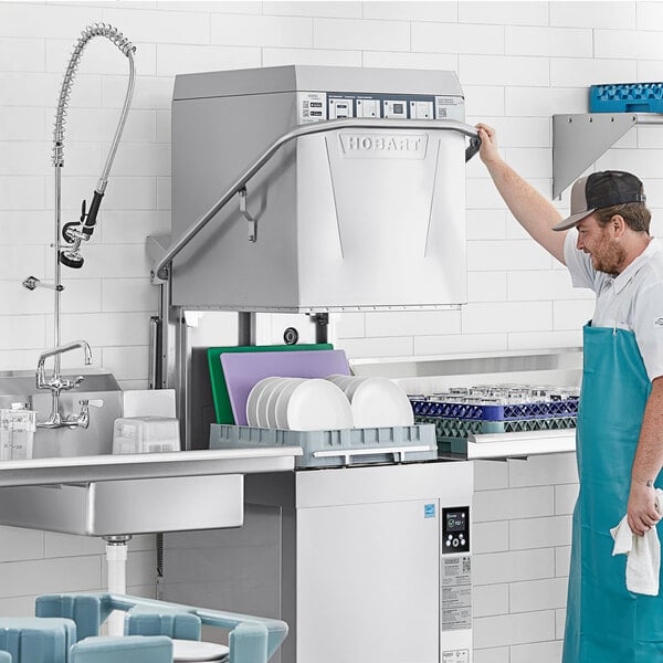 A commercial Hobart high temperature door-style electric dishwasher with a booster heater in a kitchen setting.