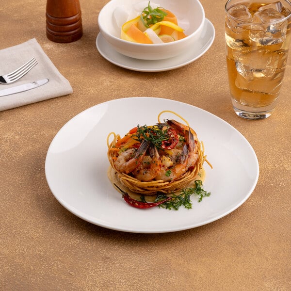 An 8 1/4 inch warm white round slanted porcelain coupe flat plate with food served on it.