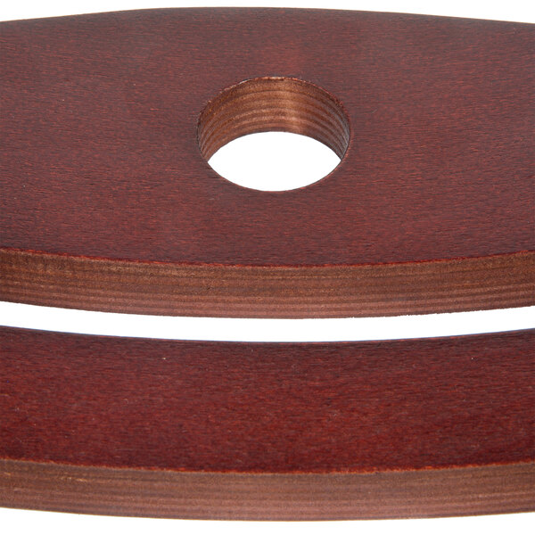 A wooden bistro chair backrest with a mahogany finish and a circular cutout in the center.