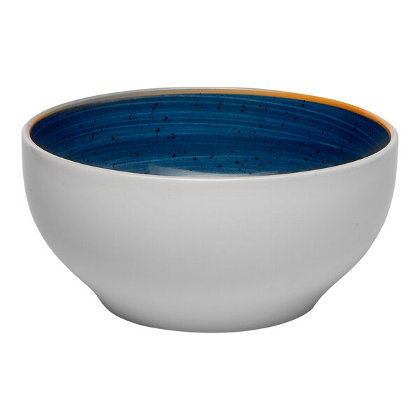 A round porcelain bowl with a white exterior and a blue speckled interior, featuring a slight yellow accent on the rim.