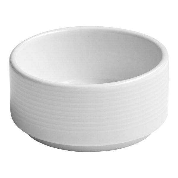 A small white embossed porcelain butter ramekin.