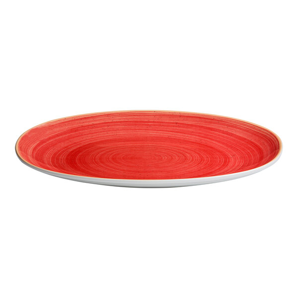 An oval porcelain bowl with a wide rim and a red swirl pattern.
