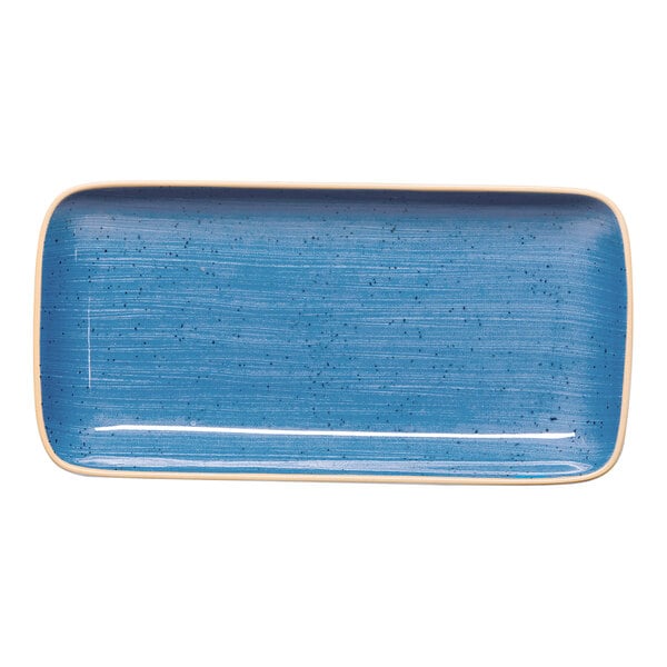 A blue rectangular coupe porcelain plate with a speckled design and rounded edges.