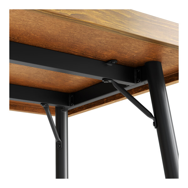 A black metal table base supporting a rectangular wooden tabletop.