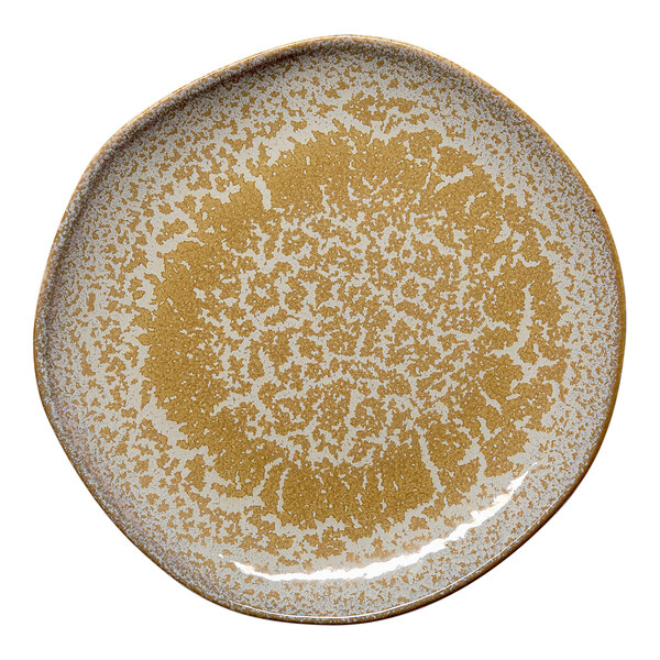 An irregular round porcelain flat plate with a gold and brown speckled pattern.
