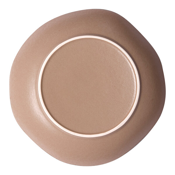 An irregular round gold and brown porcelain deep plate viewed from the bottom.