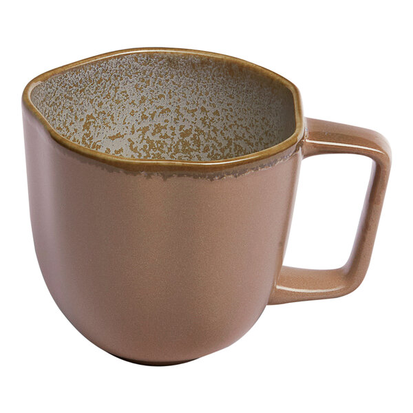 A gold and brown porcelain cup with a textured interior and a square handle.