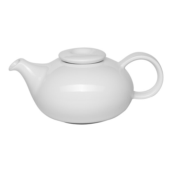 A white porcelain teapot with a lid and a rounded handle.