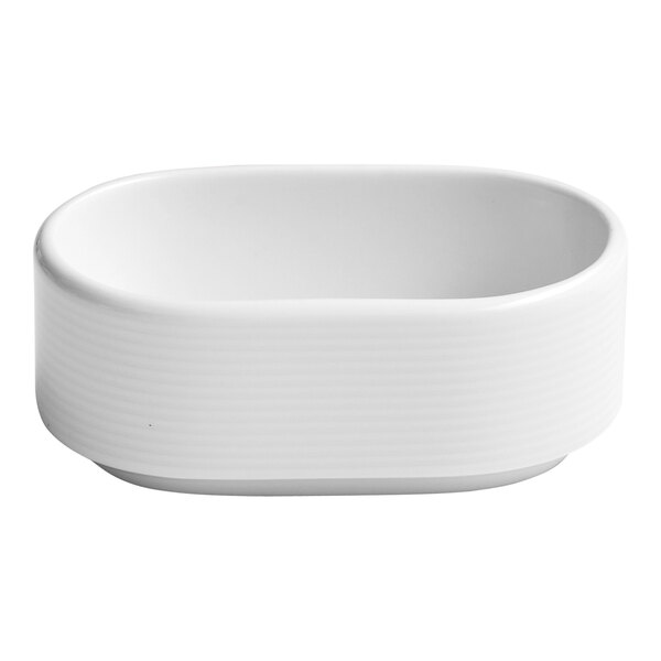 An oval white embossed porcelain sugar packet holder.