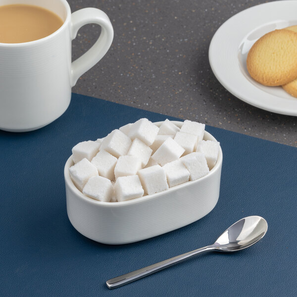 Ariane Orba 3 1/2" x 2" White Oval Embossed Porcelain Sugar Packet Holder - 12/Case