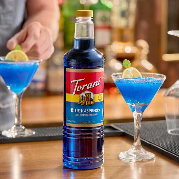A 1-liter plastic bottle of Torani Blue Raspberry flavoring and fruit syrup.