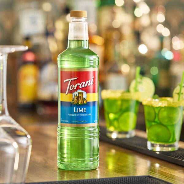 A 1-liter plastic bottle of Torani Lime flavoring and fruit syrup.