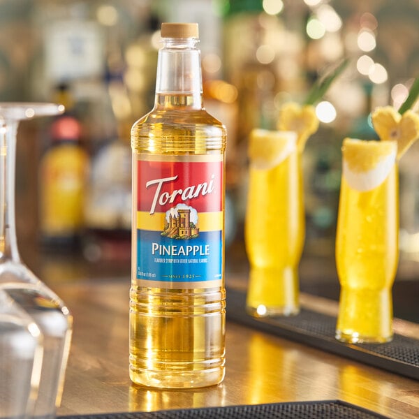 A 1-liter plastic bottle of Torani Pineapple flavoring syrup.