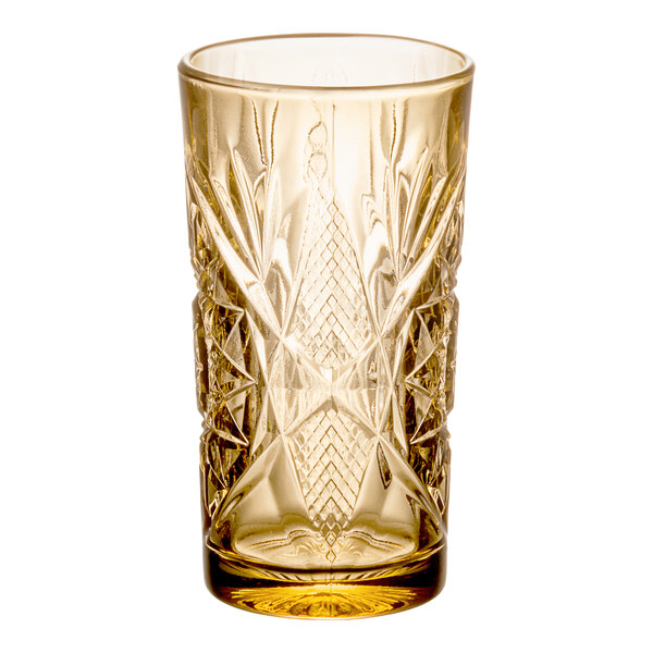 A 16 oz. topaz-colored cooler glass with an intricate cut-glass pattern.