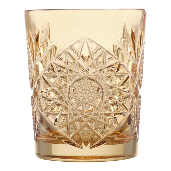 A 12 oz. topaz-colored glass with an intricate, embossed geometric pattern.